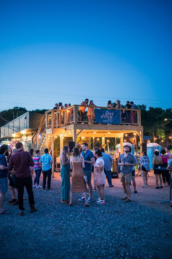 An Open House Austin gathering around a two-level outdoor deck
